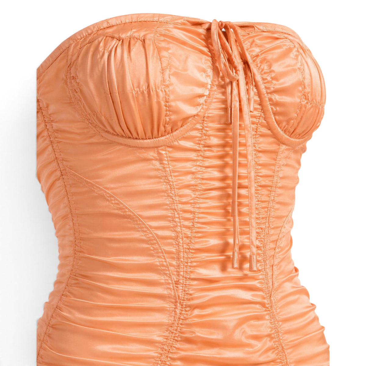Melato apricot stretch-silk corset dress featuring sculpted underwire cups, directional ruching, and a center-front tie