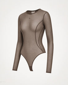 Angled view of the Melato Body Language Cocoa Mesh Bodysuit with sheer cocoa finish, sculpted seamwork, long sleeves, and tonal M chest detail.