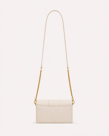 Return to Sender chain wallet detail showing ivory leather and gold-tone hardware