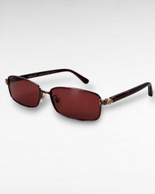 Tinted Testimony maroon metal sunglasses with red nylon lenses front three-quarter view
