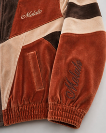 Melato Passion Fruit Velour Track Jacket close up — premium velour paneling