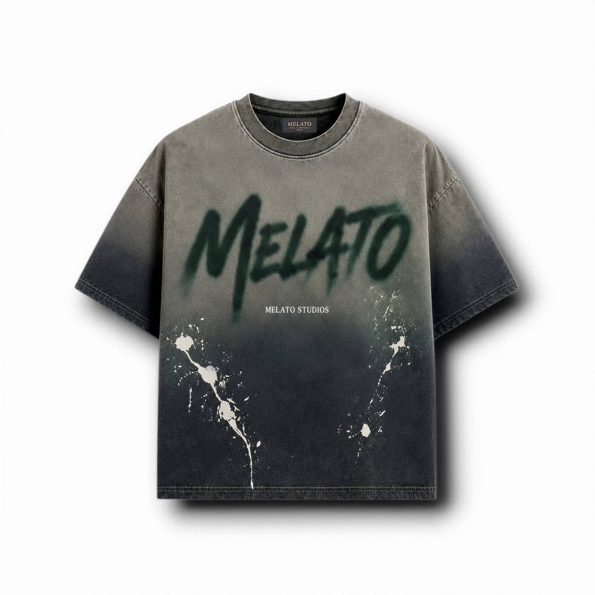 A short-sleeve crewneck t-shirt with a dark gray to black gradient wash, featuring a large green spray-paint style 'MELATO' graphic on the chest, smaller 'MELATO STUDIOS' text, and white paint splatters near the lower front.